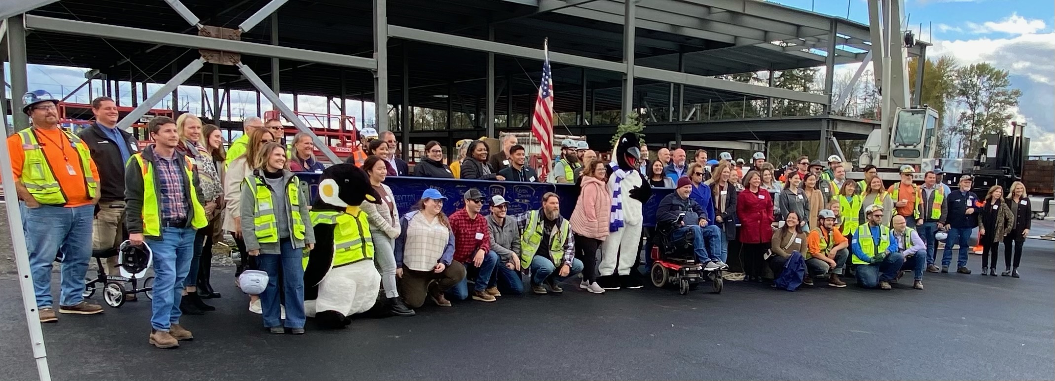 large group posed with beam 