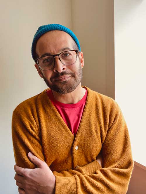 A headshot of Poet Anis Mojgani