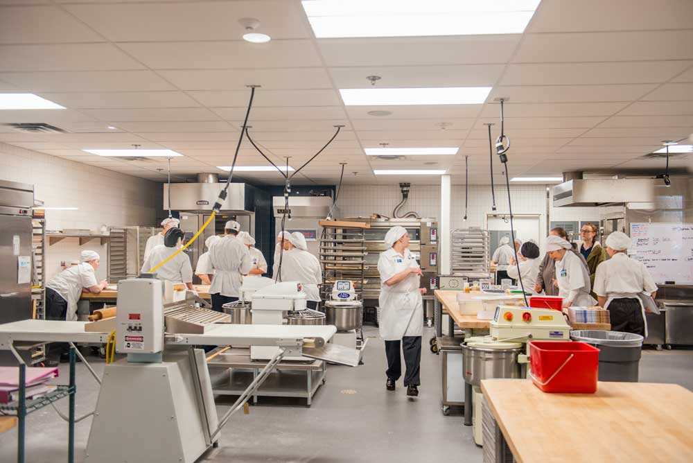 McClaskey Culinary Institute's bustling kitchen full of culinary students during one of the certification tests