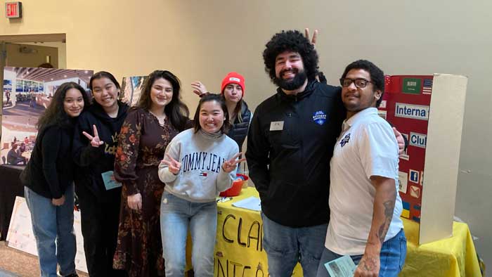 A group of international students smiling and posing for a photo