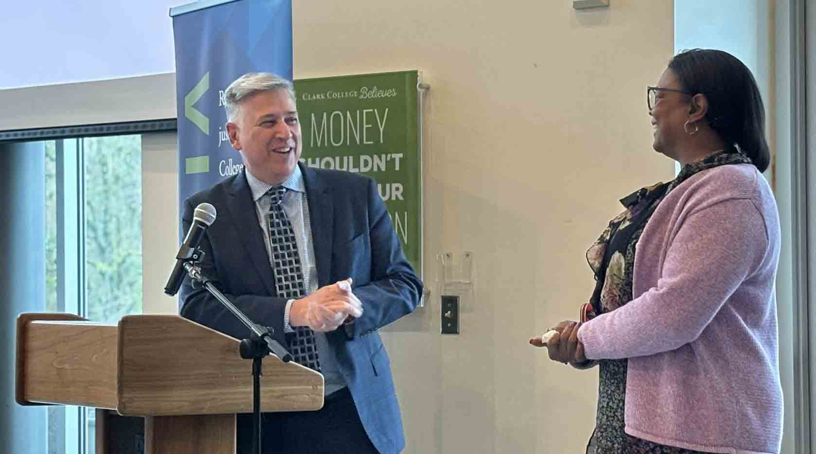 Mel Netzhammer and Dr Edwards on the podium, smiling to each other.