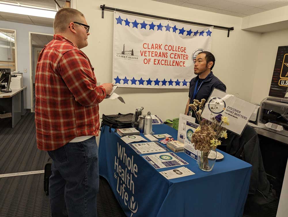 ASCC VP David Goebel talks with a representative from Whole Health for Life during Veterans Center open house