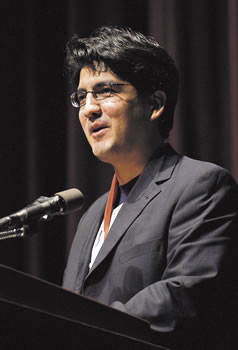 Sherman Alexie speaking at a podium