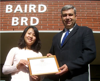 Clark College President Robert K. Knight congratulates scholarship recipient Trang Tran