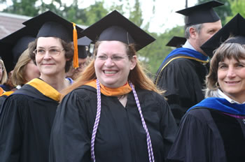 Clark College faculty members smile at graduates as they enter the Clark College Amphitheater for Commencement 2006. 