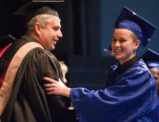 President Bob Knight congratuates a 2010 Clark graduate